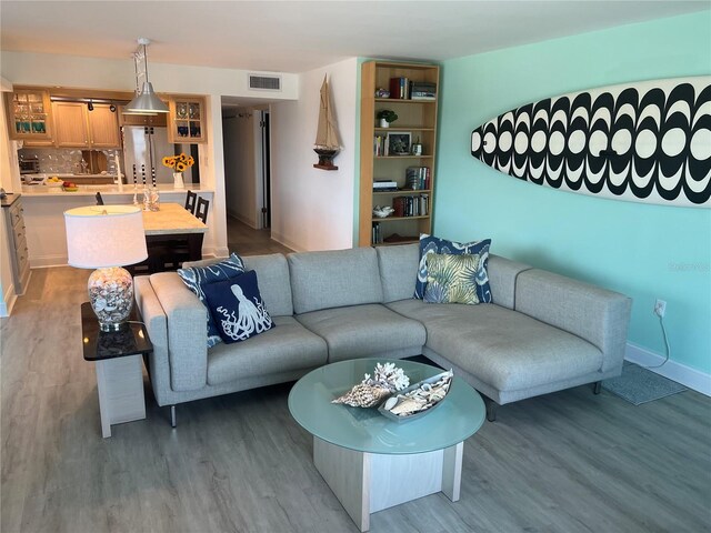 5207 S Atlantic Ave Unit 0622, New Smyrna Beach, FL 32169 - living room with baseboards, wood finished floors, and visible vents