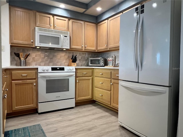 kitchen with light hardwood / wood-style floors, backsplash, and white appliances