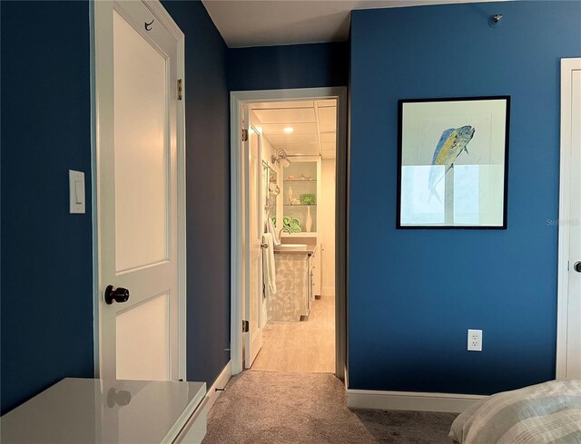 5207 S Atlantic Ave Unit 0622, New Smyrna Beach, FL 32169 - carpeted bedroom featuring baseboards and ensuite bathroom