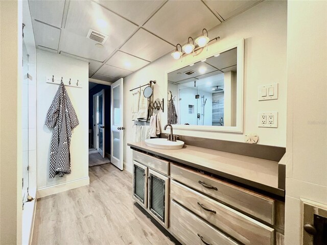 5207 S Atlantic Ave Unit 0622, New Smyrna Beach, FL 32169 - bathroom featuring baseboards, visible vents, wood finished floors, and vanity