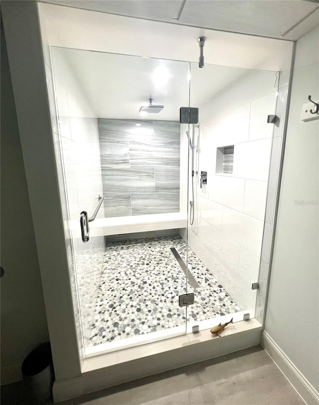 bathroom featuring a shower with door