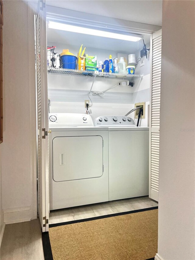 5207 S Atlantic Ave Unit 0622, New Smyrna Beach, FL 32169 - laundry area with laundry area, wood finished floors, and washer and dryer