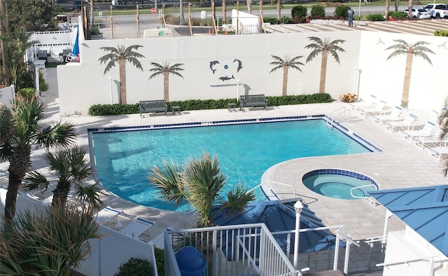 view of pool featuring a patio area and a community hot tub