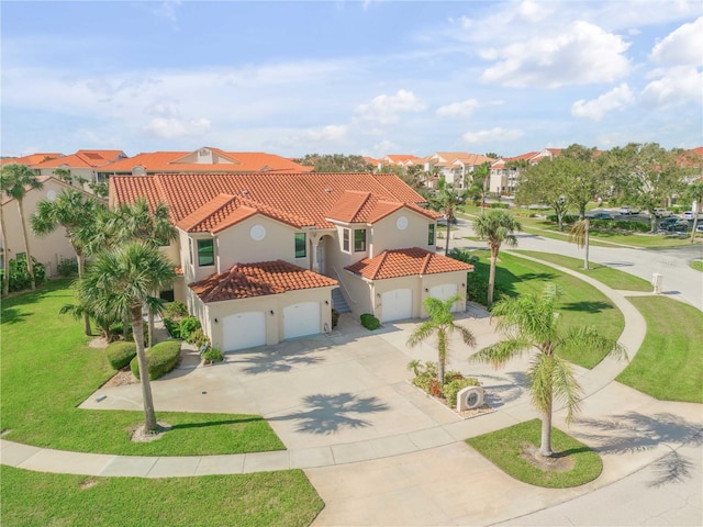 view of front of home with a garage and a front lawn