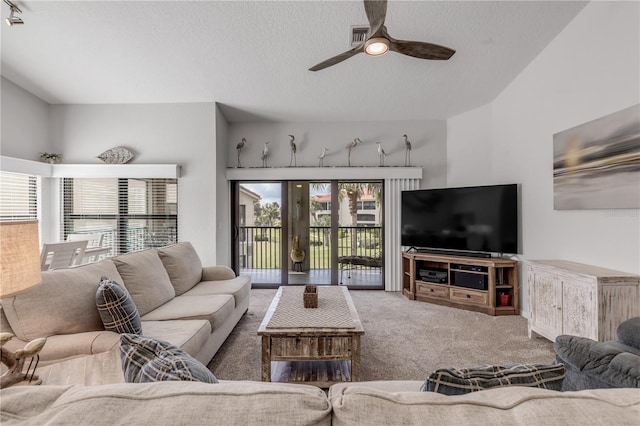 carpeted living room with ceiling fan and a textured ceiling