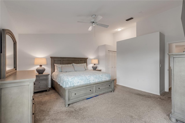 carpeted bedroom with vaulted ceiling, a closet, and ceiling fan