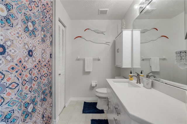 bathroom featuring vanity, a textured ceiling, toilet, and tile patterned flooring