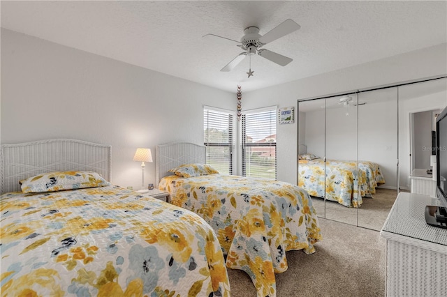 bedroom featuring ceiling fan, light carpet, and a textured ceiling