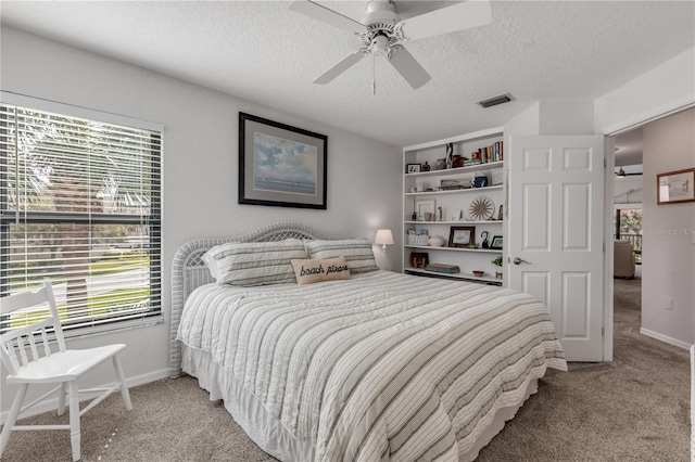 carpeted bedroom with a textured ceiling and ceiling fan