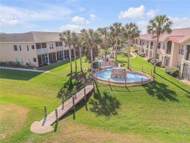 surrounding community with a pool and a lawn