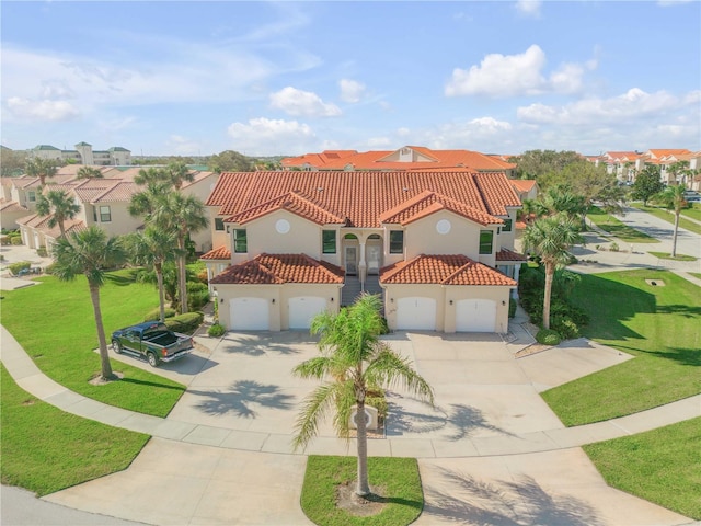 mediterranean / spanish-style home with a front lawn and a garage