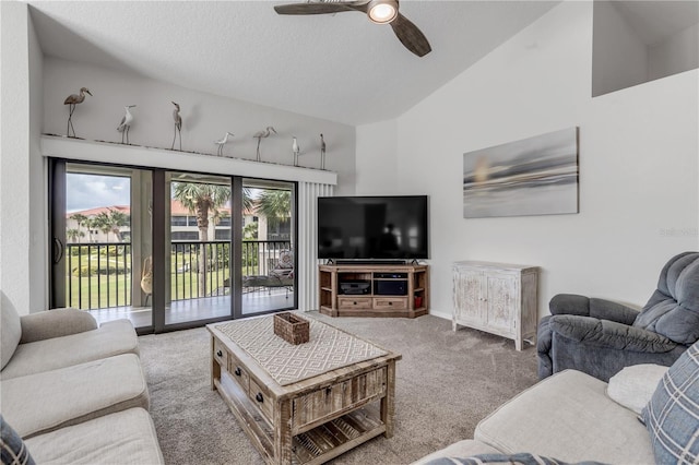 living room with a textured ceiling, high vaulted ceiling, carpet flooring, and ceiling fan