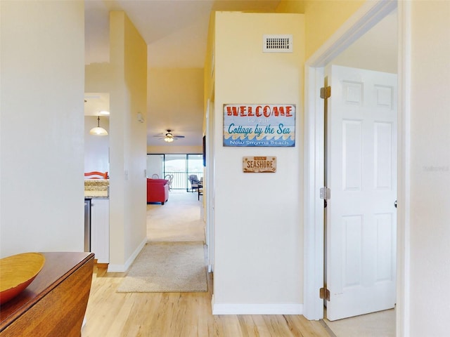 452 Bouchelle Dr Unit 303, New Smyrna Beach, FL 32169 - hallway with light wood finished floors and baseboards
