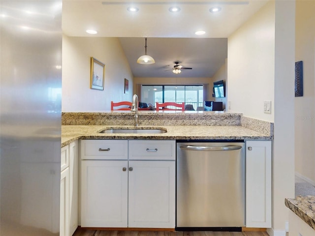 452 Bouchelle Dr Unit 303, New Smyrna Beach, FL 32169 - kitchen featuring appliances with stainless steel finishes, a sink, white cabinets, a ceiling fan, and light stone countertops