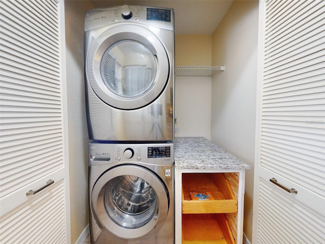 clothes washing area featuring stacked washer and dryer