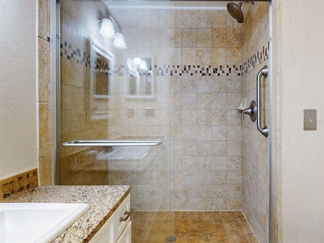 bathroom featuring vanity and a shower with door