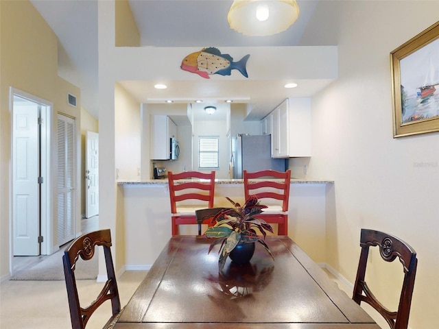 dining room with light colored carpet