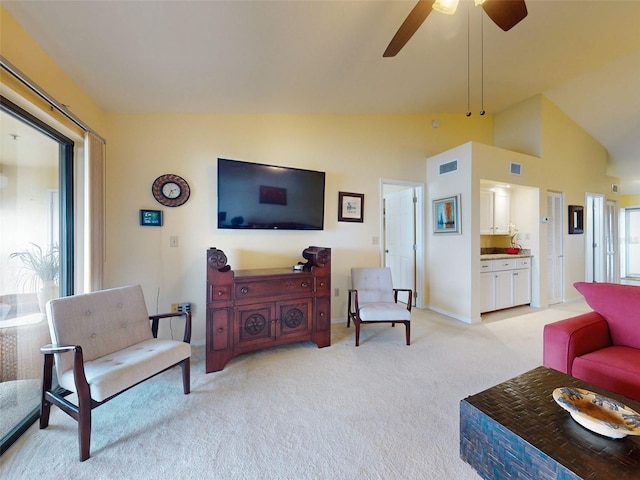 carpeted living room featuring high vaulted ceiling and ceiling fan