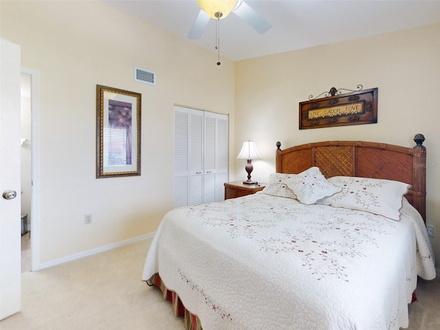 bedroom with light carpet, ceiling fan, and a closet