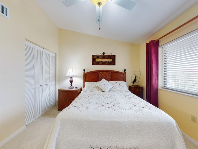 carpeted bedroom with lofted ceiling, ceiling fan, and a closet