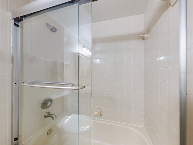 bathroom featuring bath / shower combo with glass door