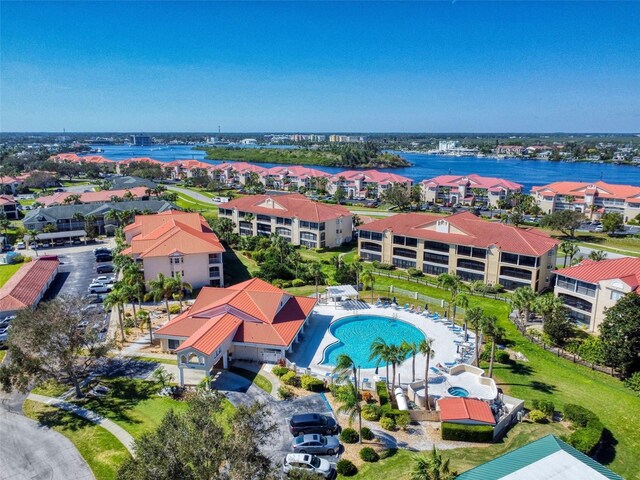 452 Bouchelle Dr Unit 303, New Smyrna Beach, FL 32169 - drone / aerial view of a pool and a nearby body of water
