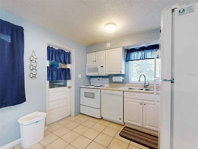 kitchen with white cabinets, a textured ceiling, sink, light tile patterned flooring, and white appliances