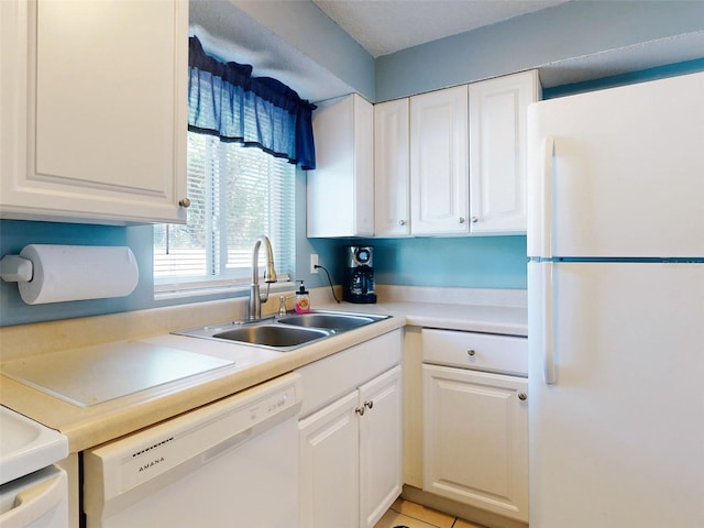 kitchen with white cabinetry, sink, white appliances, and light tile patterned floors