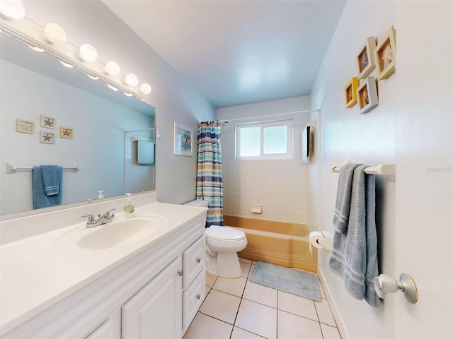 full bathroom featuring tile patterned flooring, vanity, toilet, and shower / tub combo