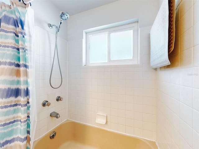 bathroom with shower / bathtub combination with curtain