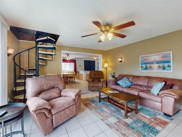 tiled living room featuring a textured ceiling and ceiling fan