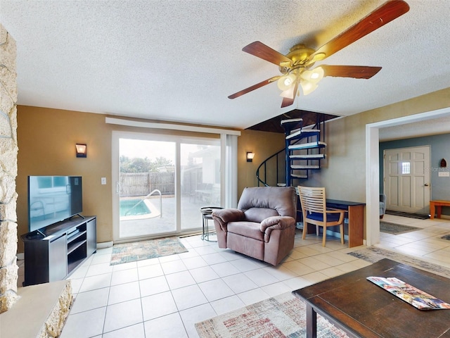 tiled living room with a textured ceiling and ceiling fan