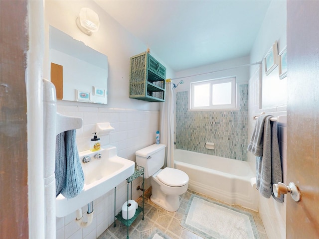 bathroom with toilet, shower / tub combo with curtain, tile walls, and tile patterned floors