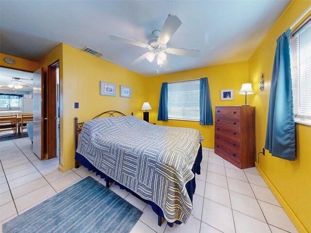 bedroom with ceiling fan and light tile patterned floors