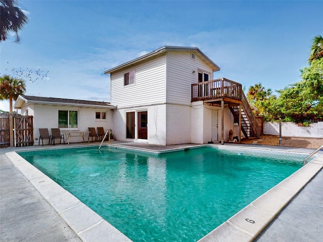 view of swimming pool with a patio and a deck