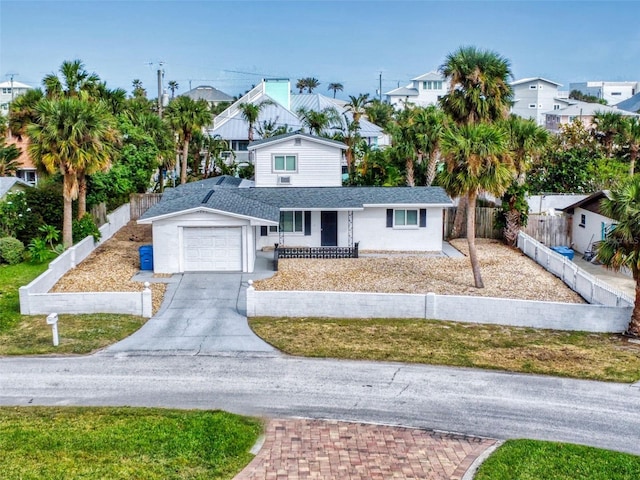 view of front of property featuring a garage and a front lawn