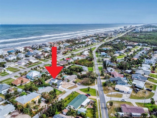 aerial view with a water view and a view of the beach