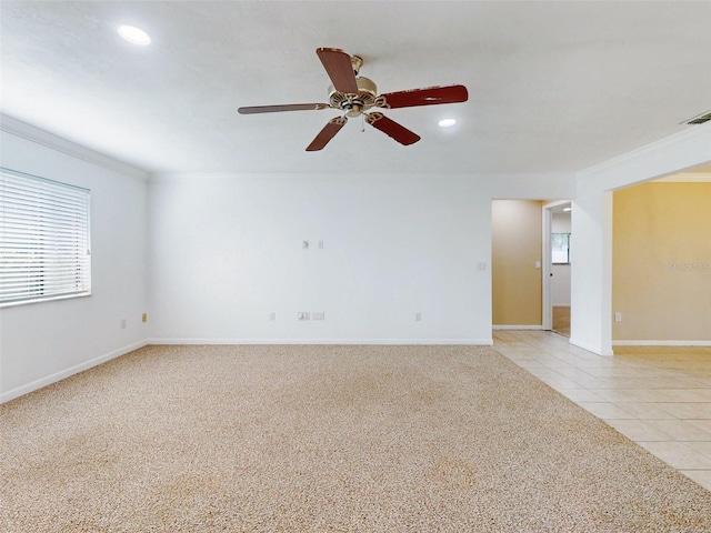 unfurnished room featuring ceiling fan, crown molding, and light tile patterned flooring