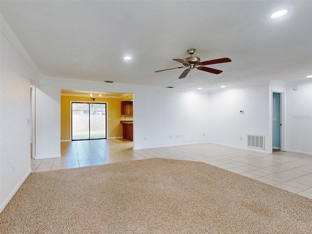 carpeted empty room featuring ceiling fan and ornamental molding