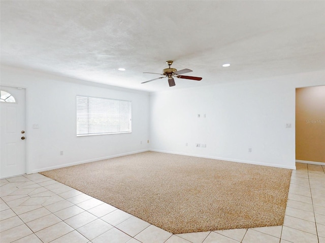 spare room featuring ceiling fan and light tile patterned floors