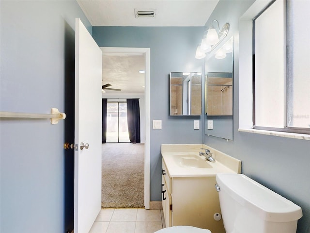 bathroom featuring tile patterned flooring, vanity, toilet, and ceiling fan