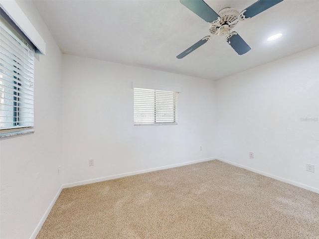 spare room featuring carpet floors and ceiling fan