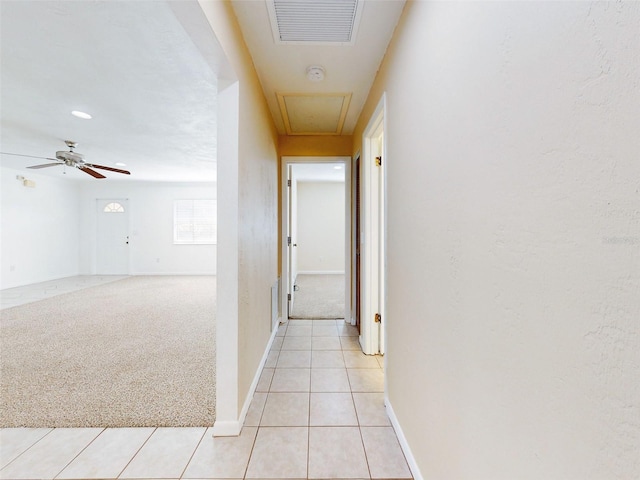 hallway featuring light carpet