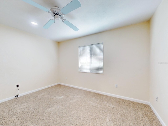 spare room featuring carpet and ceiling fan