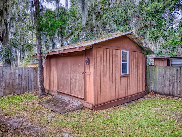 view of outbuilding with a lawn