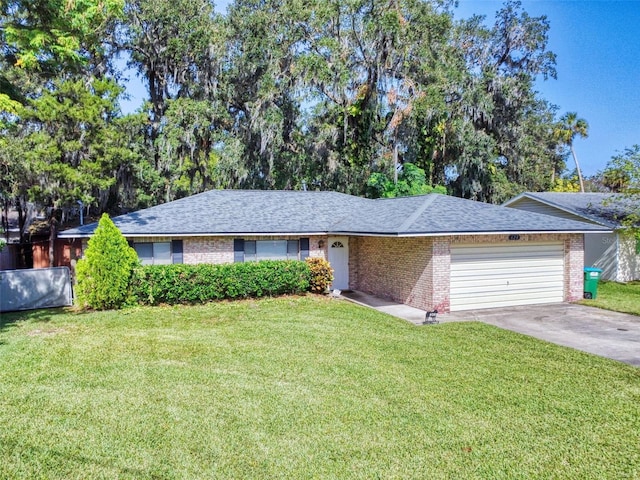 single story home featuring a garage and a front lawn