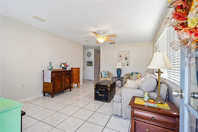 tiled living room with ceiling fan