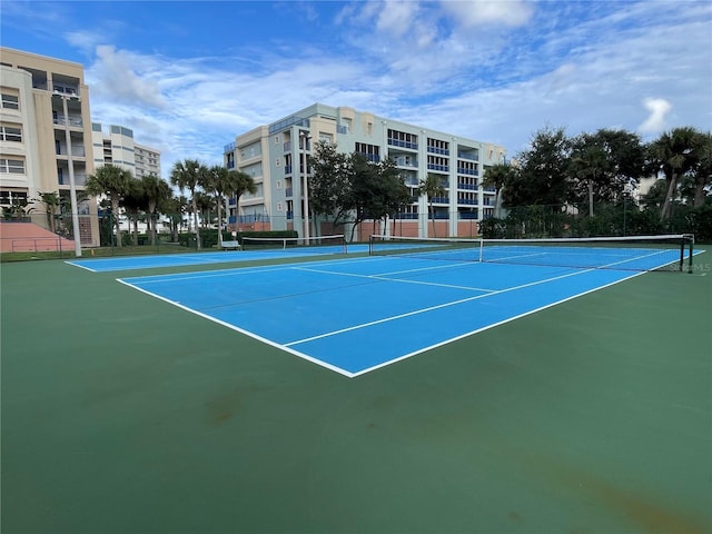 view of tennis court featuring fence