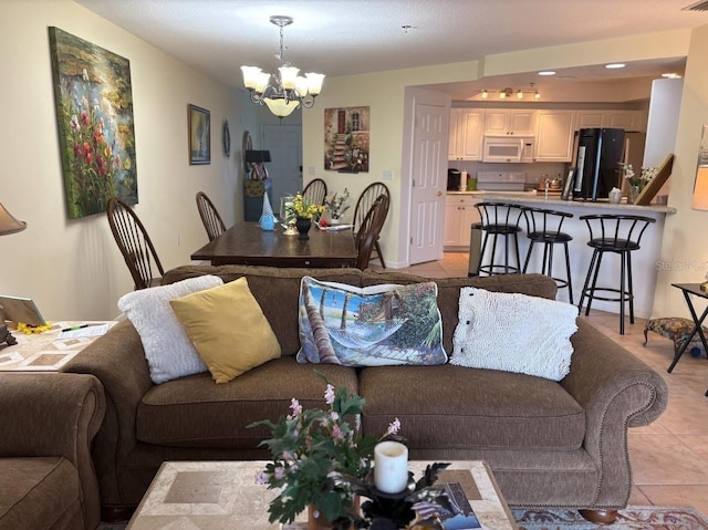 living area featuring a chandelier, visible vents, and light tile patterned flooring