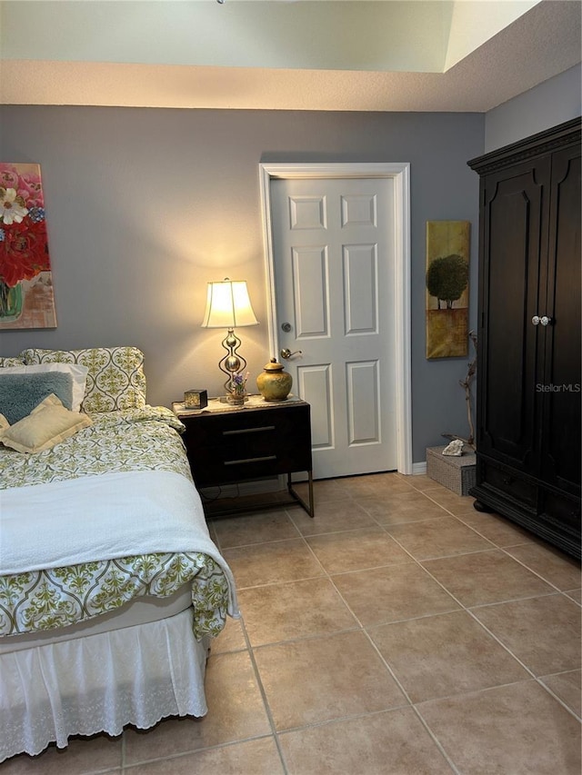 bedroom featuring light tile patterned floors